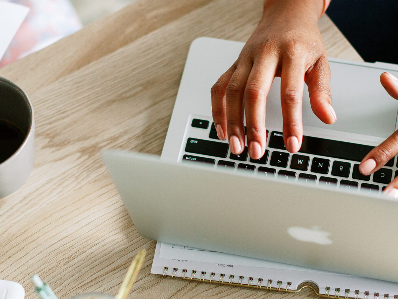 hand typing on a laptop