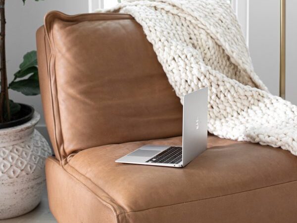 a laptop resting on top of a leather couch - can i look at pinterest without an account