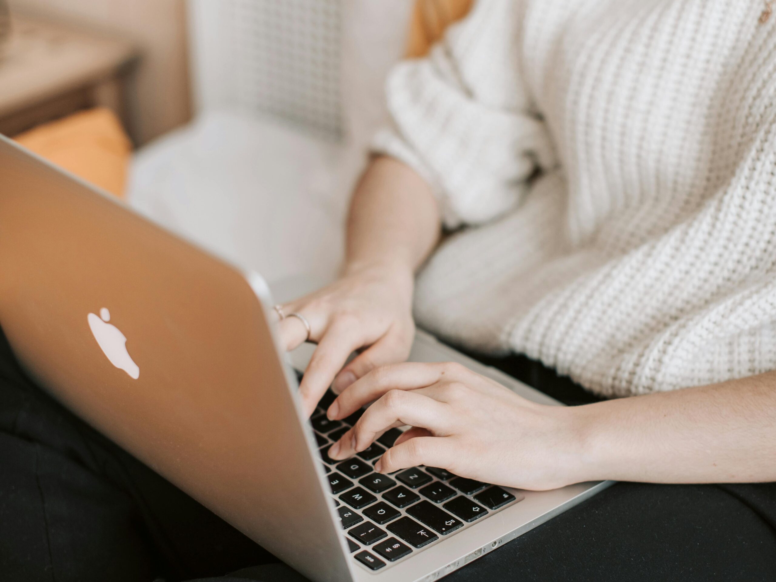 a woman sitting while typing on the laptop - can i look at pinterest without an account