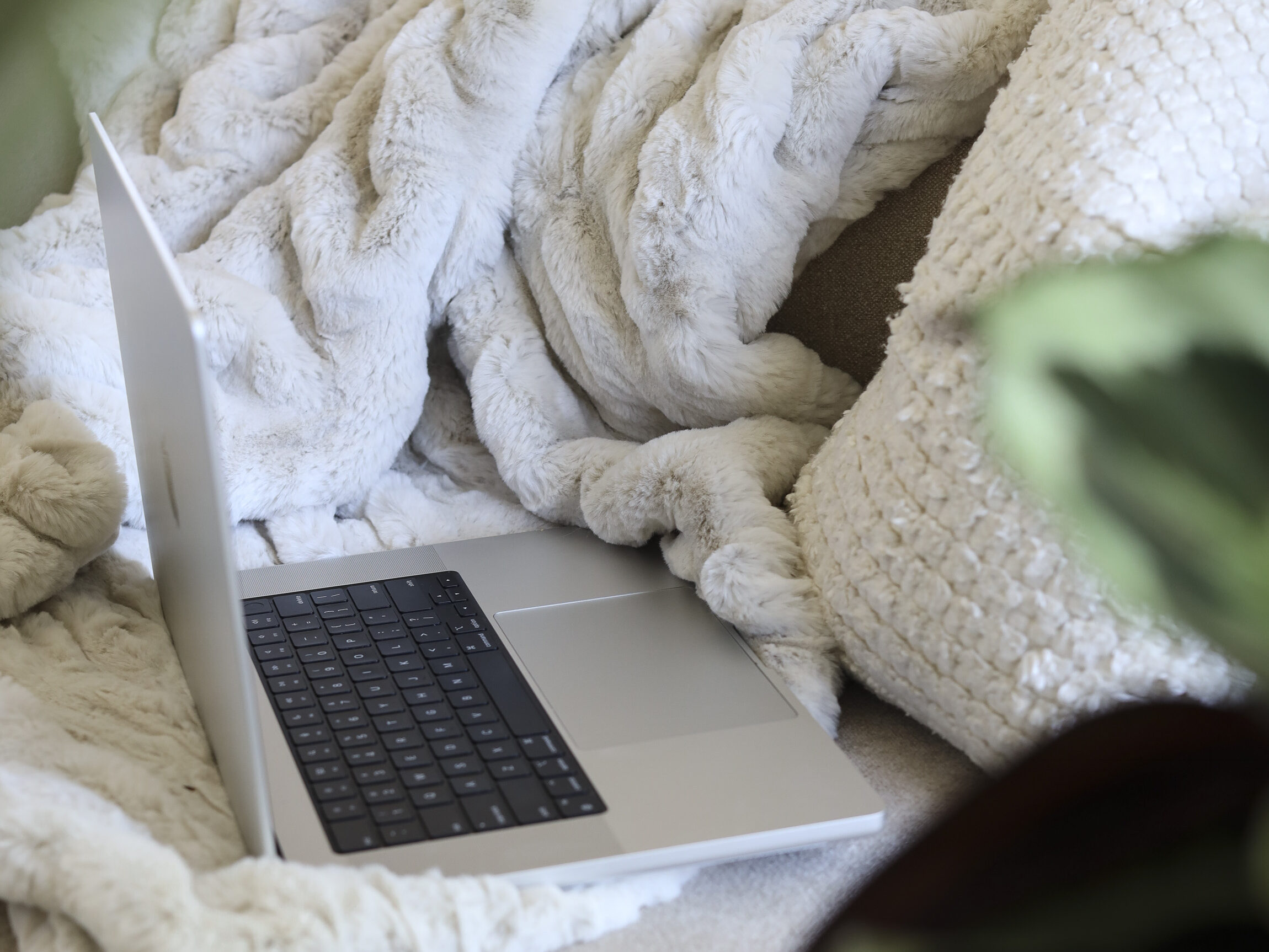 an open laptop on top of a sofa blanket - how to add link to pinterest idea pin