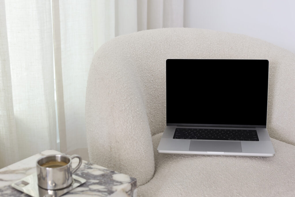 a laptop resting on a white couch - how to add link to pinterest idea pin