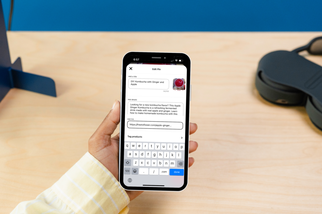 A phone showing how to add links to pinterest pin