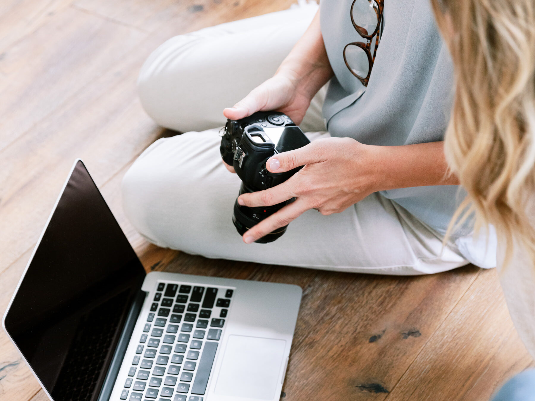 oner person holding a camera and taking photo of the laptop - how to get paid on pinterest