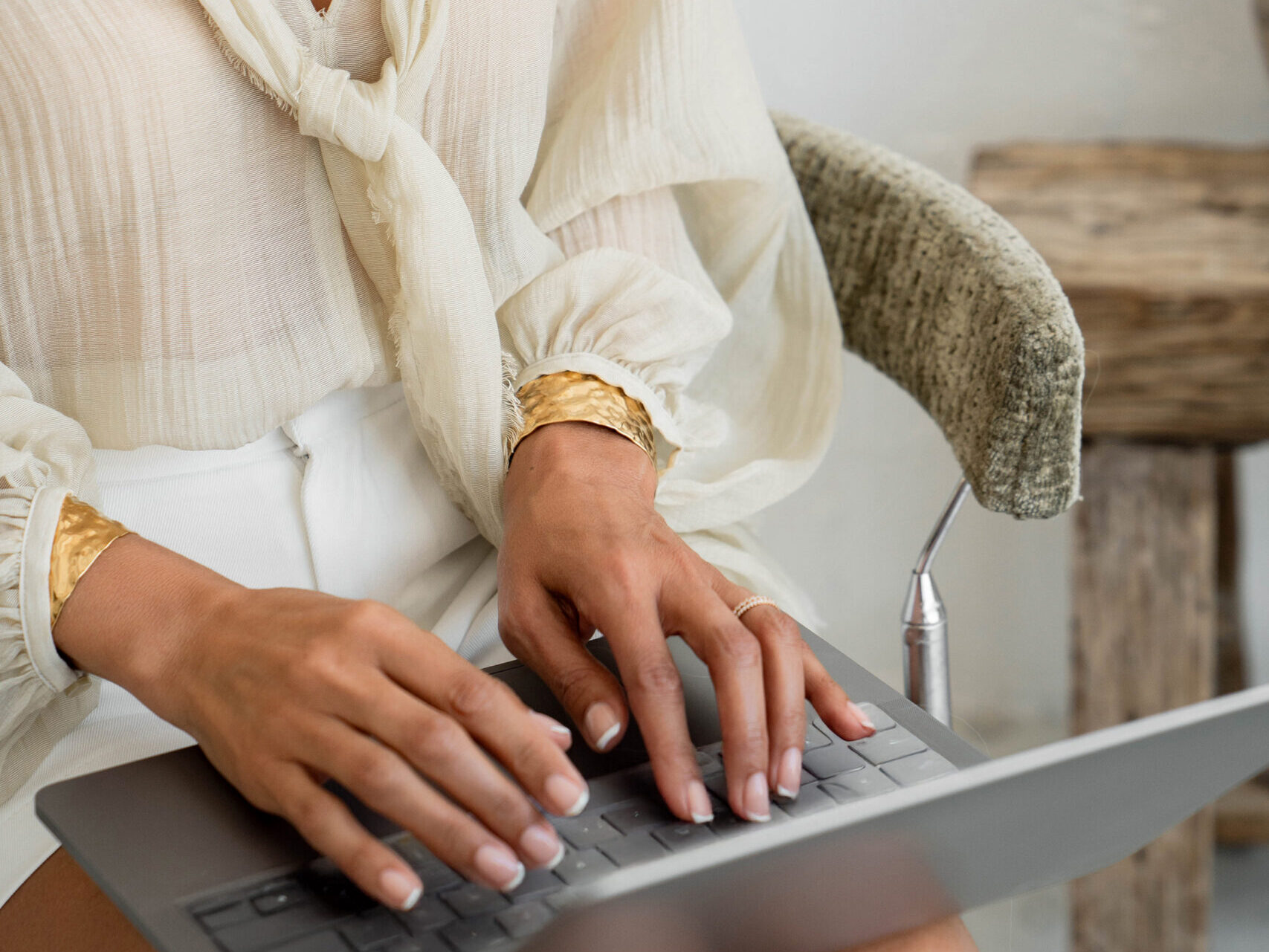 a person sitting while on typing on a laptop - how to get paid on pinterest