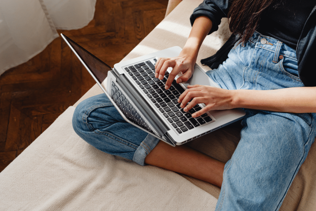 woman typing on the keyboard of a laptop