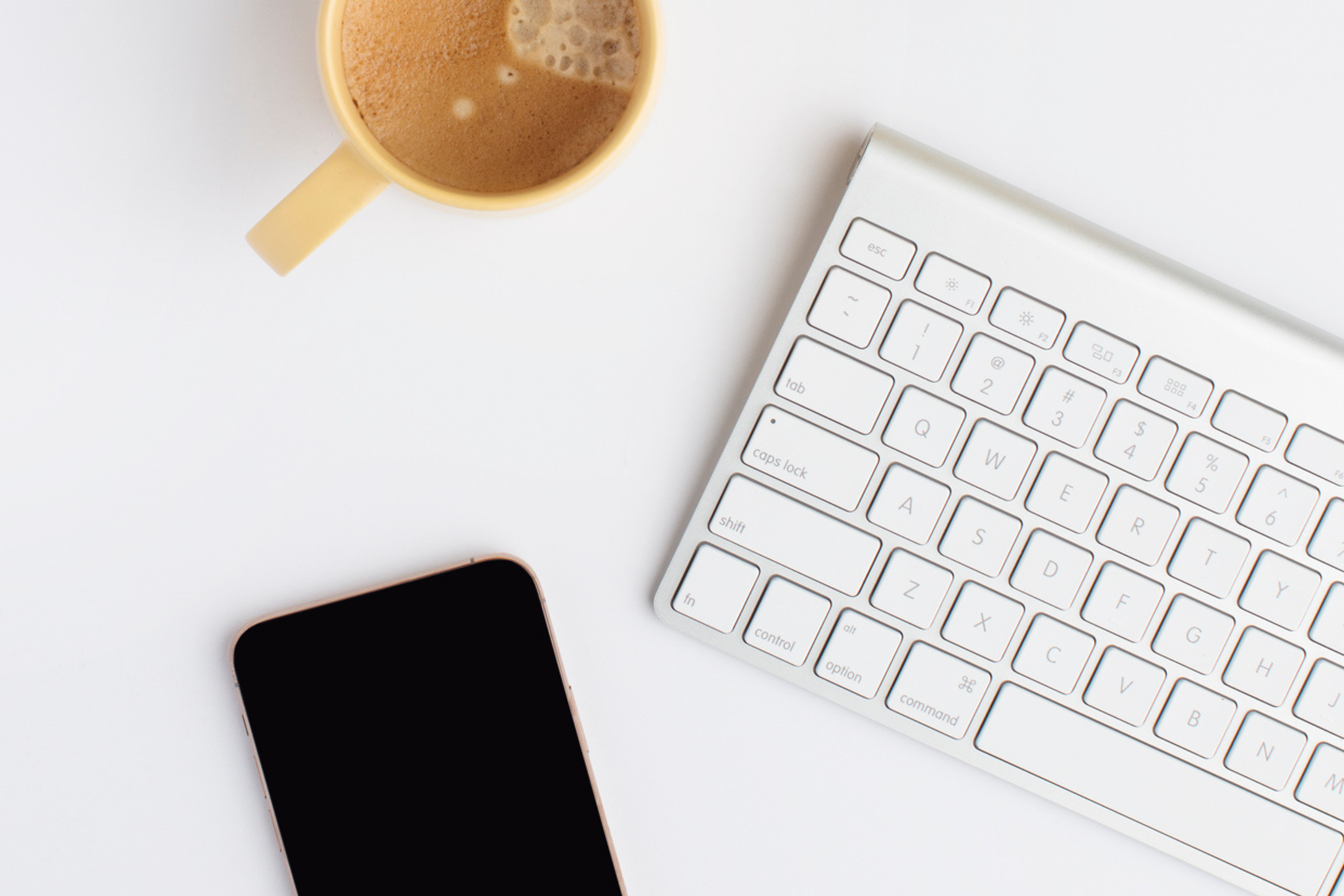 keyboard with coffee and phone