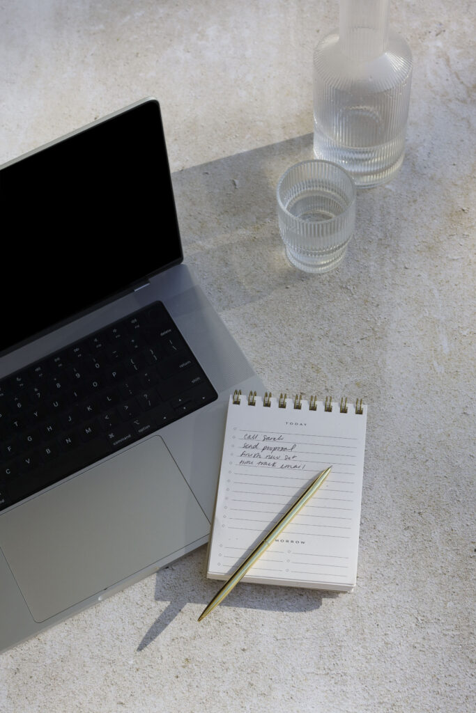a laptop with a small note - 3 things to cut for overwhelmed new bloggers
