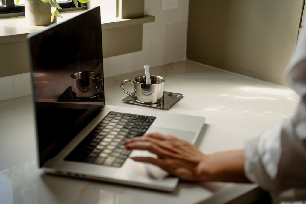 a hand resting on the laptop