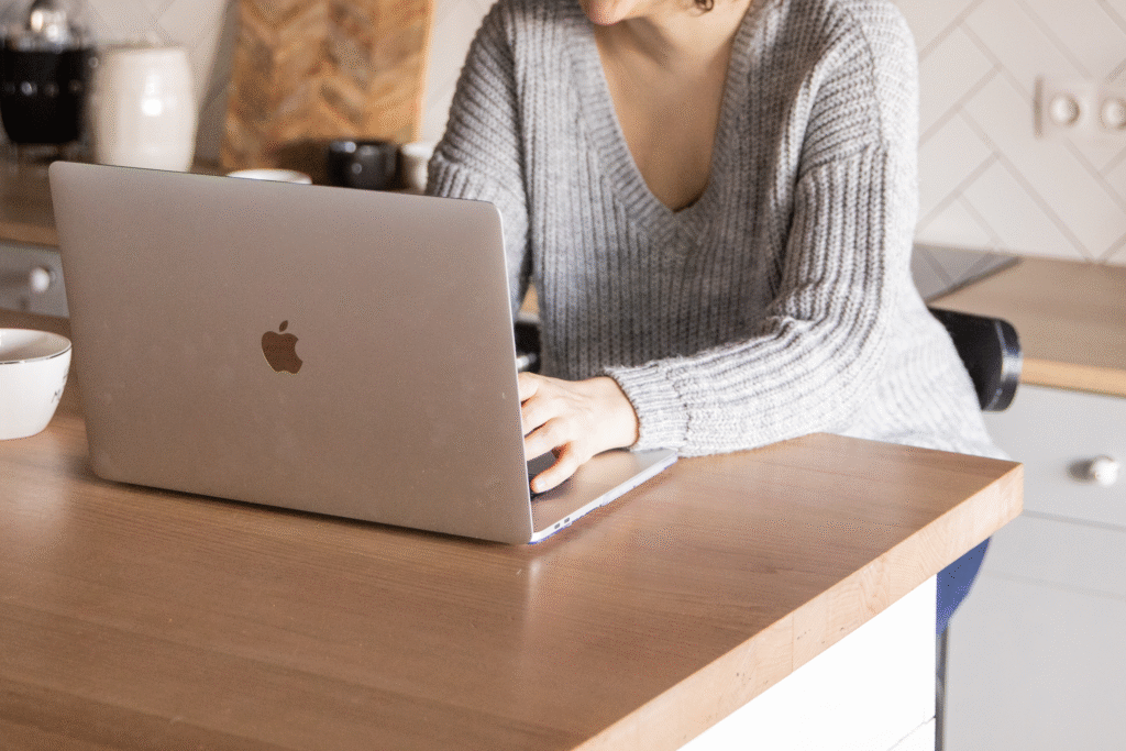a woman typing on a laptop