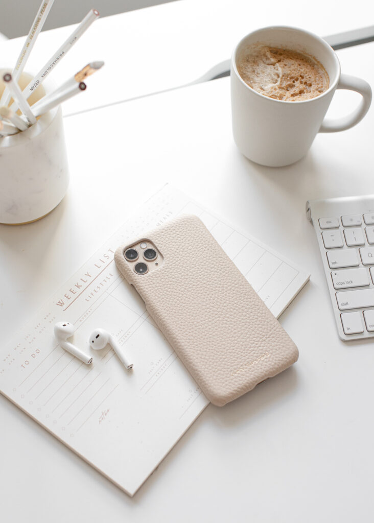 a phone with earbuds and coffee on the side