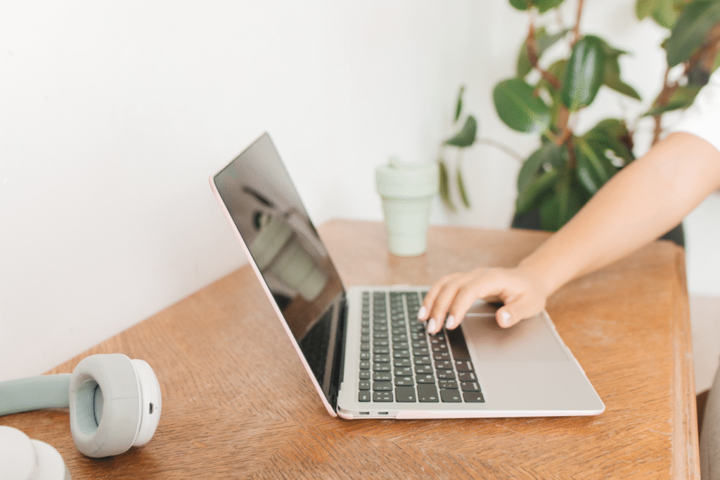 a hand resting on top of the keyboard