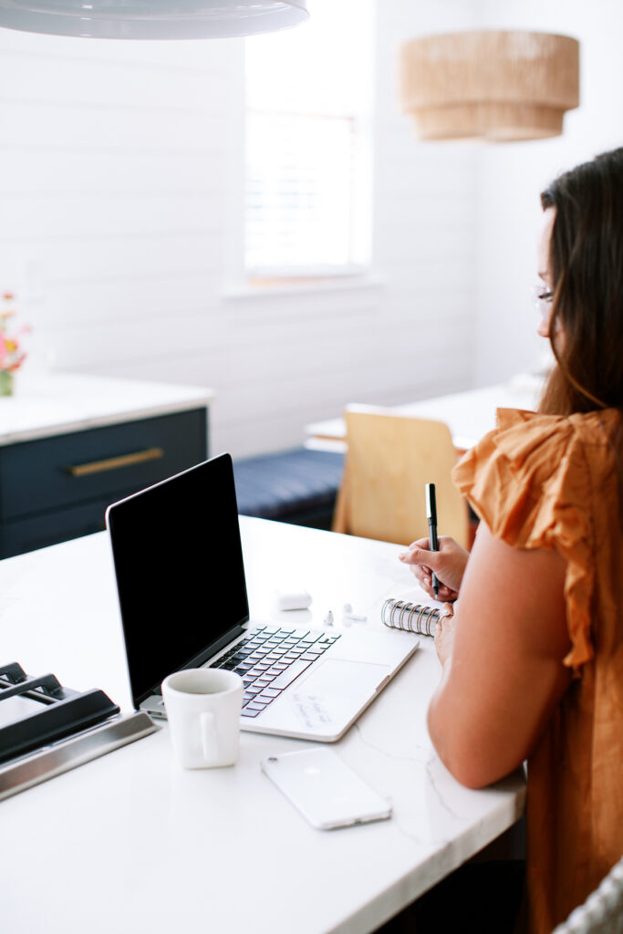 a woman looking at her laptop