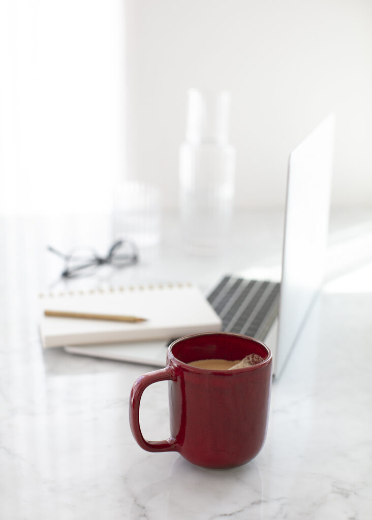 a laptop with coffee and notes